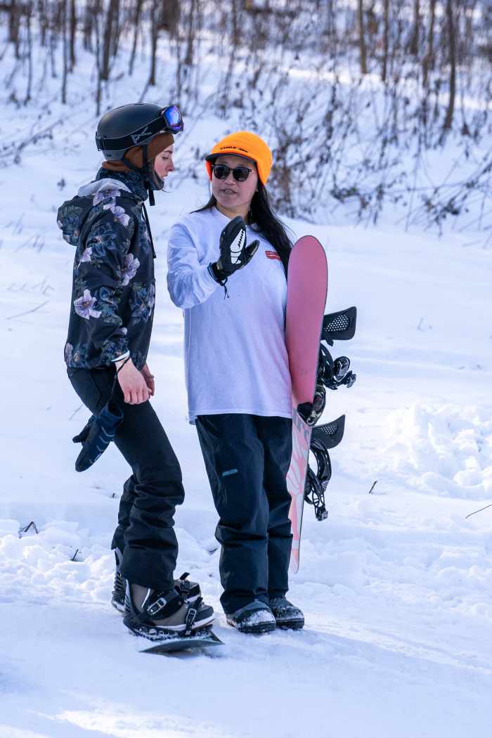 Alice Gong instructs a camper at a Beyond the Boundaries Women's Snowboard Camp at Mountain Creek