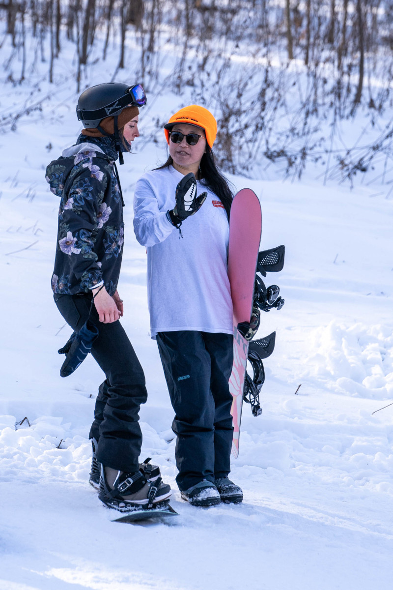Alice Gong instructs a camper at a Beyond the Boundaries Women's Snowboard Camp at Mountain Creek